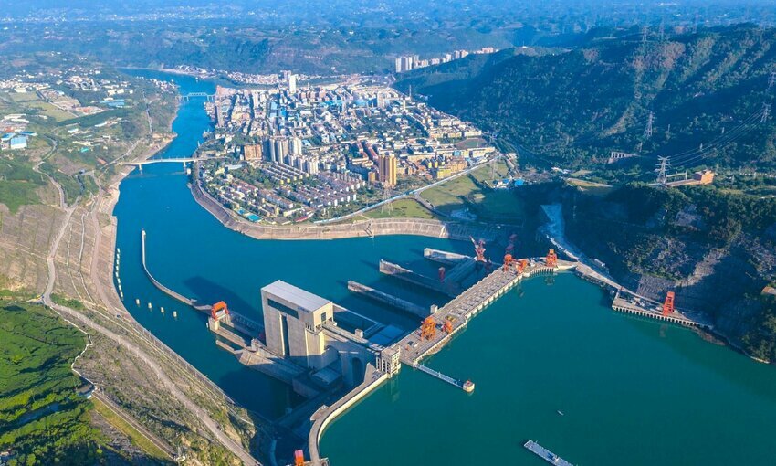 birds-eye view of hydropower plant near body of water in China